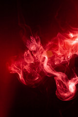 Fototapeta premium Red smoke motion on black background.