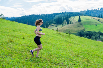 Healthy lifestyle woman trail runner running on mountain peak.