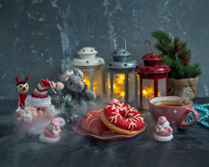 Tea party on a magical Christmas evening, Christmas card with Christmas toys and sweet painted cakes