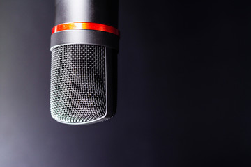 Sound studio. Microphone with cable isolated on black background