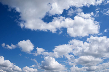 Naklejka na ściany i meble Beautiful blue sky with white fluffy clouds. Background.