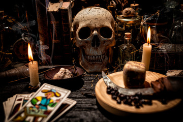 Tarot cards, skull and magic items.