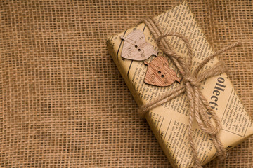 gift box with hearts and space for text on sackcloth background. Valentine's day concept.