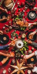 Family celebration Christmas, New Year holiday. Flat-lay of people feasting at table with red cloth with sparkling wine, roasted turkey, bundt cake, fruit, decorations, top view. Winter holiday party