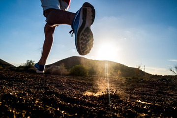close up of foot of man running alone in the mountains - active and fitness people lifesyle and...
