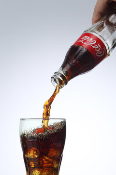 Pouring Coca Cola To Coca Cola Glass With Ice Cube