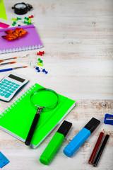 Items for the school on a wooden table.