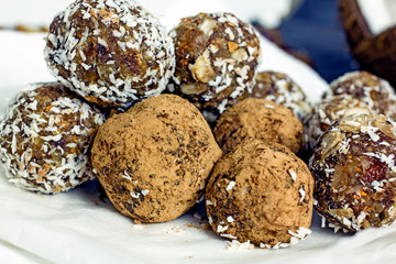Raw food dessert balls made of dates and nuts. Homemade sweets without sugar and gluten, proper nutrition, vegan sweets