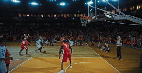 Fototapeta premium Basketball players on big professional arena during the game. Tense moment of the game. Celebration
