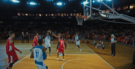 Basketball players on big professional arena during the game. Tense moment of the game. Celebration