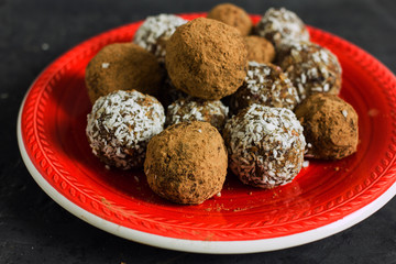Homemade sweets. Useful sweets in the form of balls of nuts, dates, coconut and dried fruits. The concept of vegan desserts and sweets without sugar.