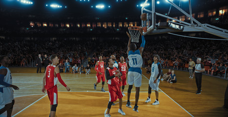 Obraz premium Basketball players on big professional arena during the game. Tense moment of the game. Celebration