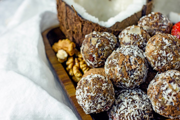 Raw food dessert balls made of dates and nuts. Homemade sweets without sugar and gluten, proper nutrition, vegan sweets