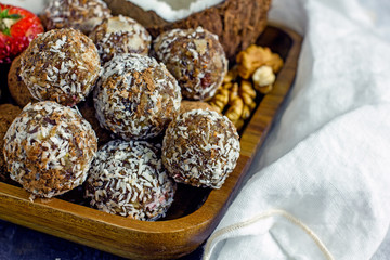 Raw food dessert balls made of dates and nuts. Homemade sweets without sugar and gluten, proper nutrition, vegan sweets