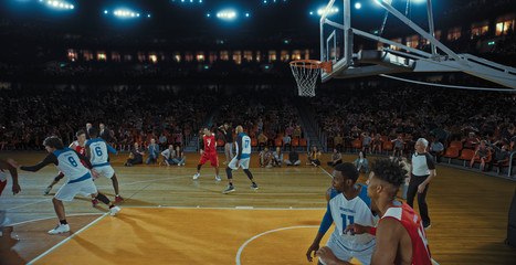 Fototapeta premium Basketball players on big professional arena during the game. Tense moment of the game. Celebration