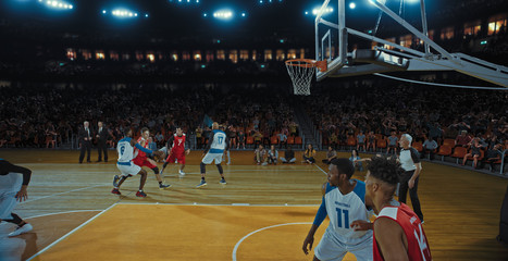 Fototapeta premium Basketball players on big professional arena during the game. Tense moment of the game. Celebration