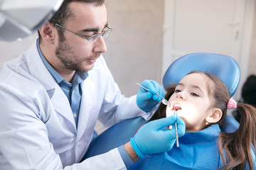 Young caucasian girl calm and happy visiting dentist's office for prevention and treatment of the...
