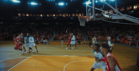 Fototapeta premium Basketball players on big professional arena during the game. Tense moment of the game. Celebration
