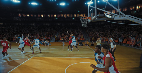 Basketball players on big professional arena during the game. Tense moment of the game. Celebration