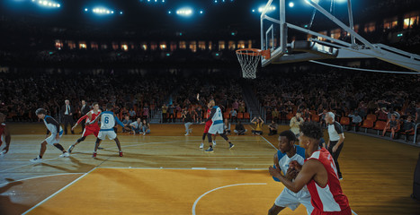 Fototapeta premium Basketball players on big professional arena during the game. Tense moment of the game. Celebration