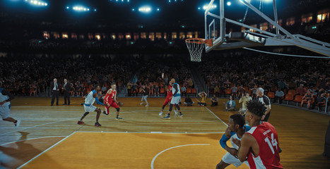 Basketball players on big professional arena during the game. Tense moment of the game. Celebration