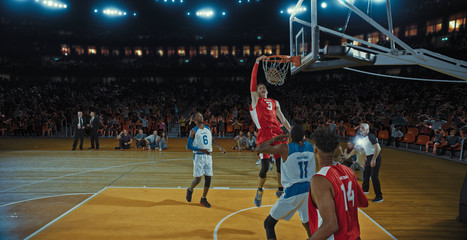 Basketball players on big professional arena during the game. Tense moment of the game. Celebration