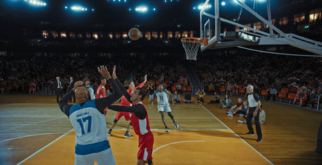 Fototapeta premium Basketball players on big professional arena during the game. Tense moment of the game. Celebration