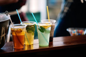 Summer refreshing lemonade in plastic cups. Street food.