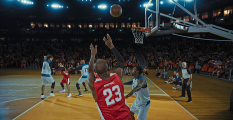 Basketball players on big professional arena during the game. Tense moment of the game. Celebration