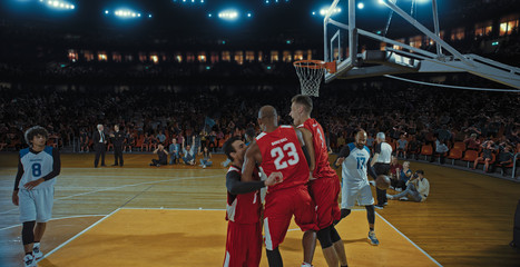 Fototapeta premium Basketball players on big professional arena during the game. Tense moment of the game. Celebration