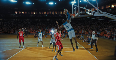 Basketball players on big professional arena during the game. Tense moment of the game. Celebration