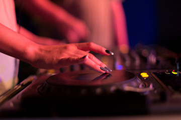 DJ mixing in a karaoke bar. Soft focus on hand - a concept of entertainment, youth, entertainment and relaxation