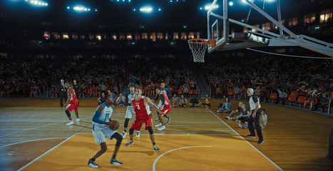Basketball players on big professional arena during the game. Tense moment of the game. Celebration