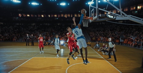 Fototapeta premium Basketball players on big professional arena during the game. Tense moment of the game. Celebration