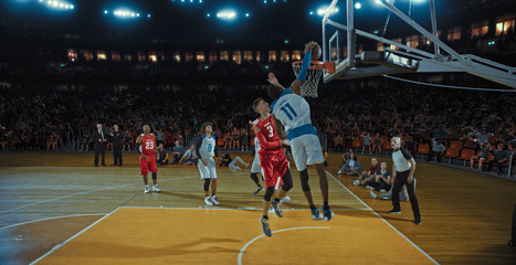 Basketball players on big professional arena during the game. Tense moment of the game. Celebration