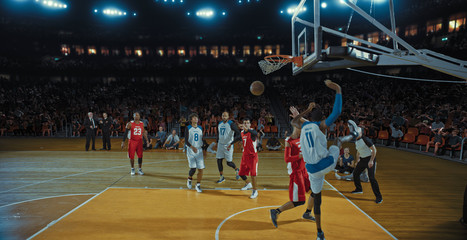 Fototapeta premium Basketball players on big professional arena during the game. Tense moment of the game. Celebration
