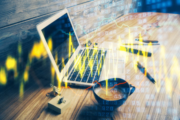 Double exposure of graph and financial info and work space with computer background. Concept of...