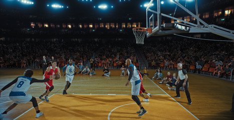 Fototapeta premium Basketball players on big professional arena during the game. Tense moment of the game. Celebration