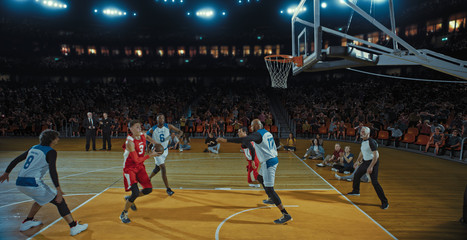 Basketball players on big professional arena during the game. Tense moment of the game. Celebration