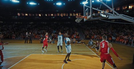 Basketball players on big professional arena during the game. Tense moment of the game. Celebration