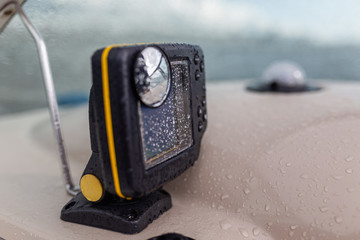 Gps navigation system in raindrops for swimming in the sea located on the dashboard of a pleasure...