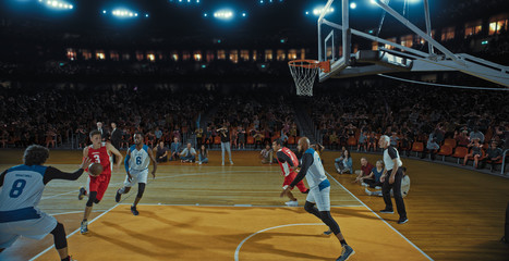 Basketball players on big professional arena during the game. Tense moment of the game. Celebration