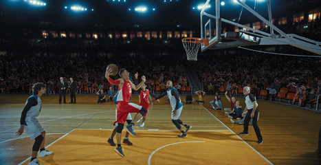 Basketball players on big professional arena during the game. Tense moment of the game. Celebration