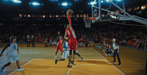 Basketball players on big professional arena during the game. Tense moment of the game. Celebration