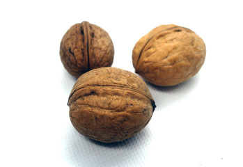 Three wallnuts on white.