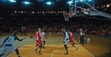 Basketball players on big professional arena during the game. Tense moment of the game. Celebration