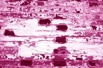 Old grungy brick wall texture in pink tone.