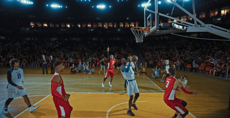 Basketball players on big professional arena during the game. Tense moment of the game. Celebration