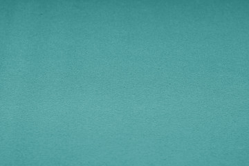 Plastic glittering texture with blur effect in cyan tone.