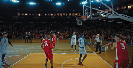 Fototapeta premium Basketball players on big professional arena during the game. Tense moment of the game. Celebration